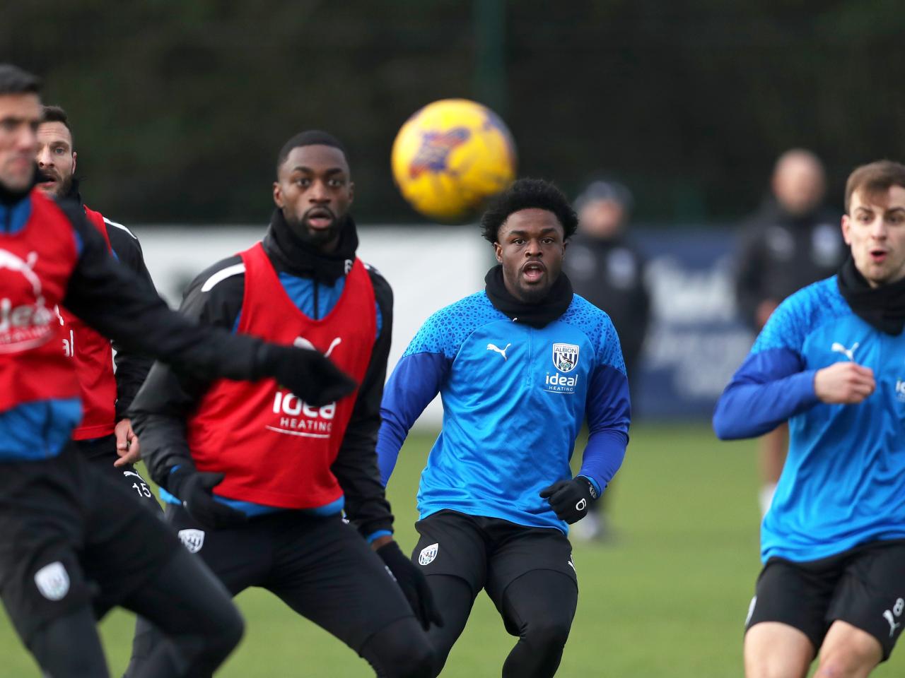 Several players looking directly at the ball during training 