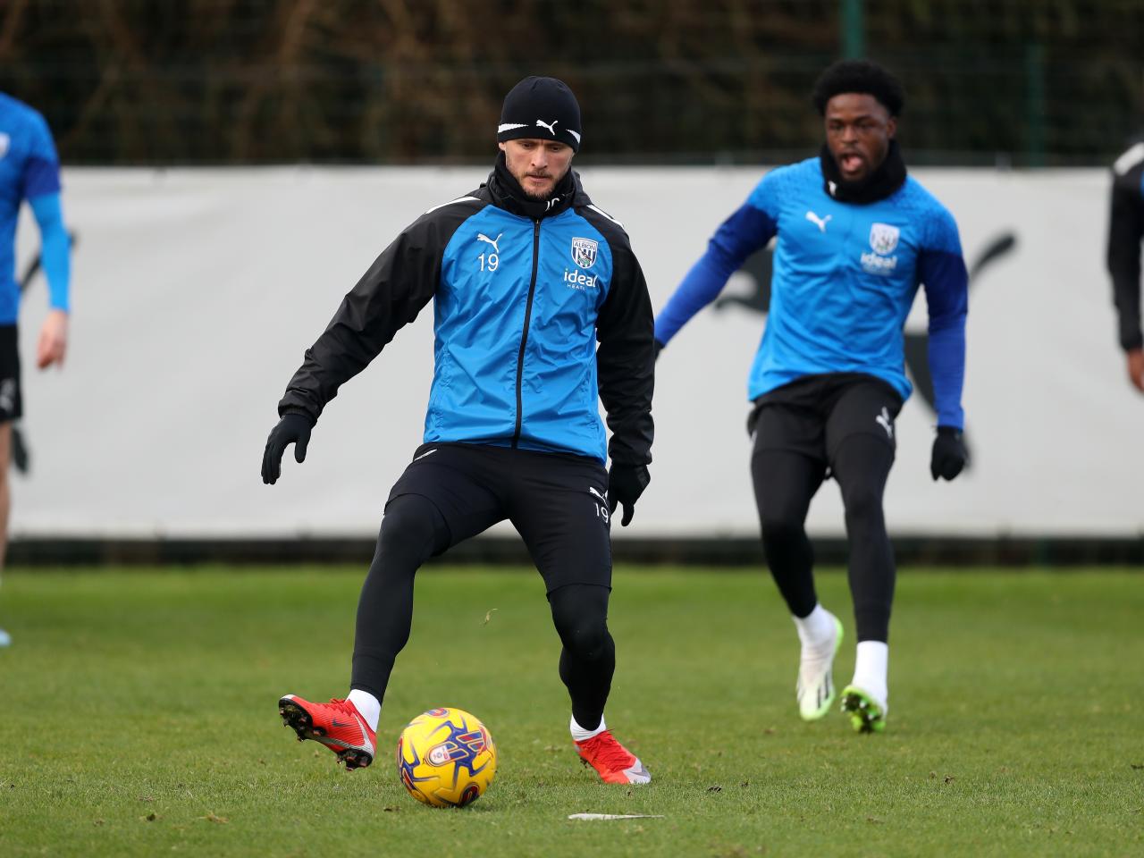 John Swift on the ball in training while wearing a hat