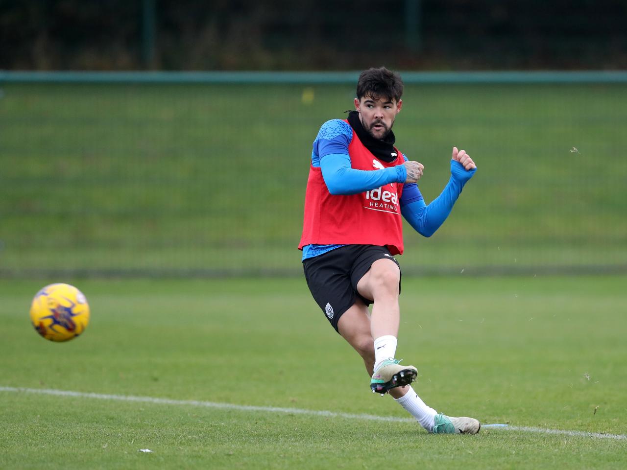 Alex Mowatt striking the ball in training 