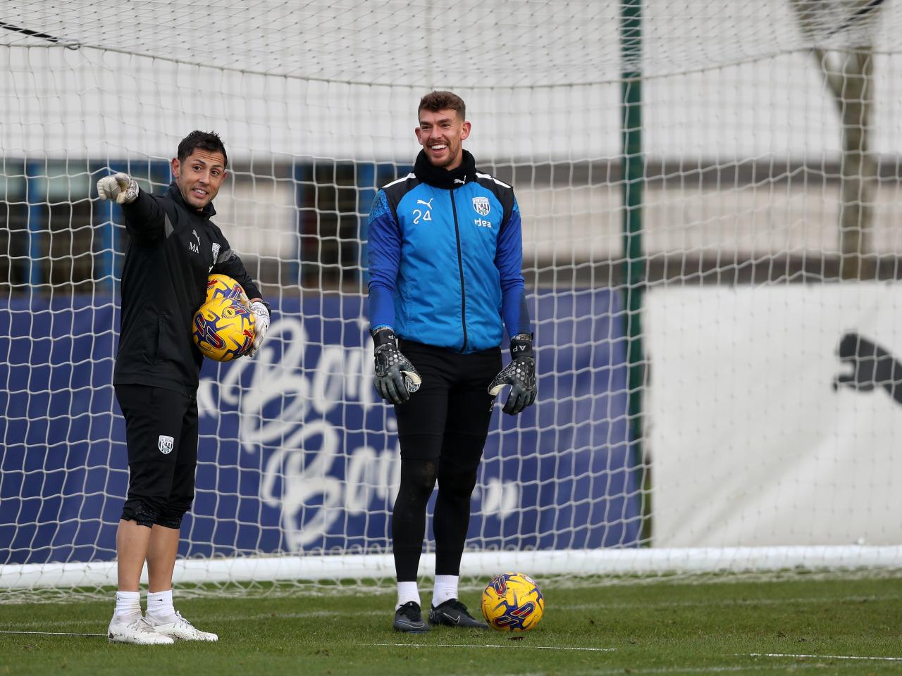 Alex Palmer laughing in training with goalkeeping coach Marcos Abad