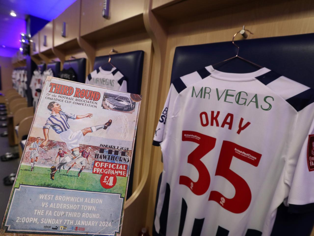The matchday programme and the back of Okay Yokuslu's shirt in the dressing room before the Aldershot game