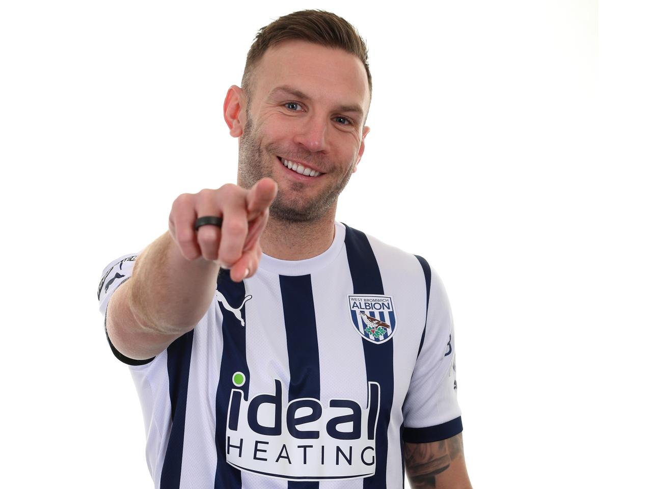 Andi Weimann pointing and smiling at the camera in the home shirt