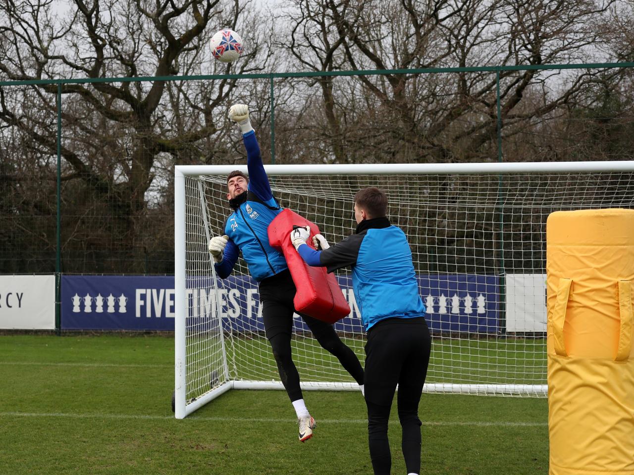 Alex Palmer punching a ball away during training 