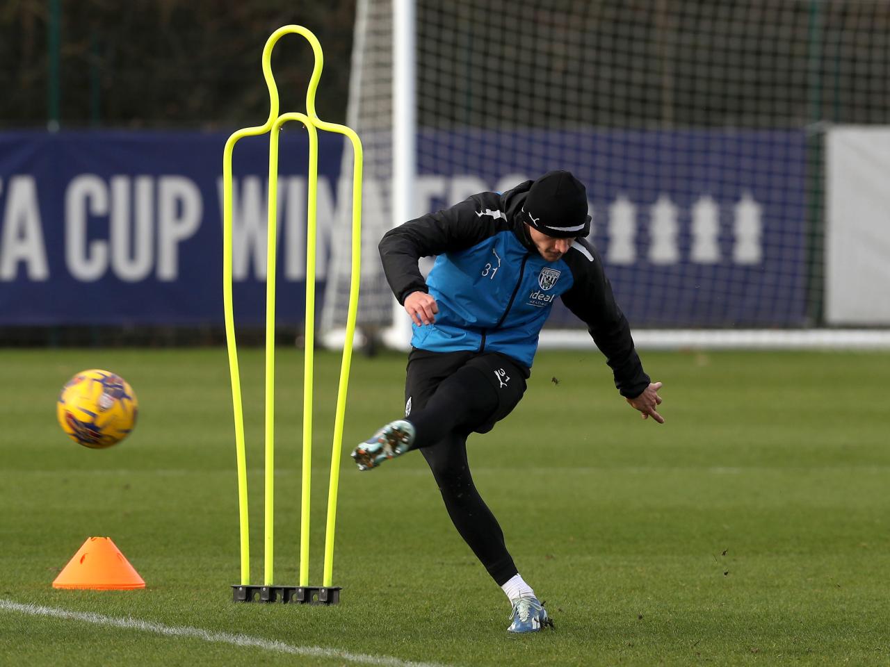 Tom Fellows striking a ball in training 