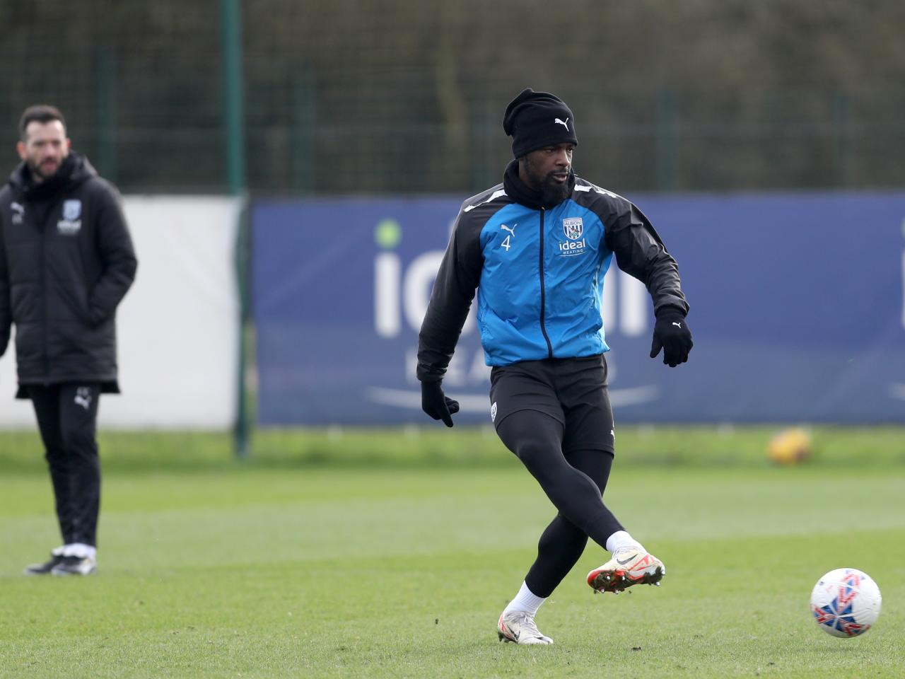 Cedric Kipre passes the ball in training 