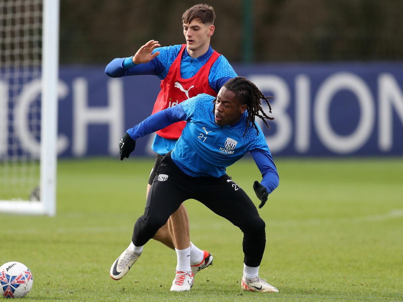 Brandon Thomas-Asante and Caleb Taylor fight for the ball in training 