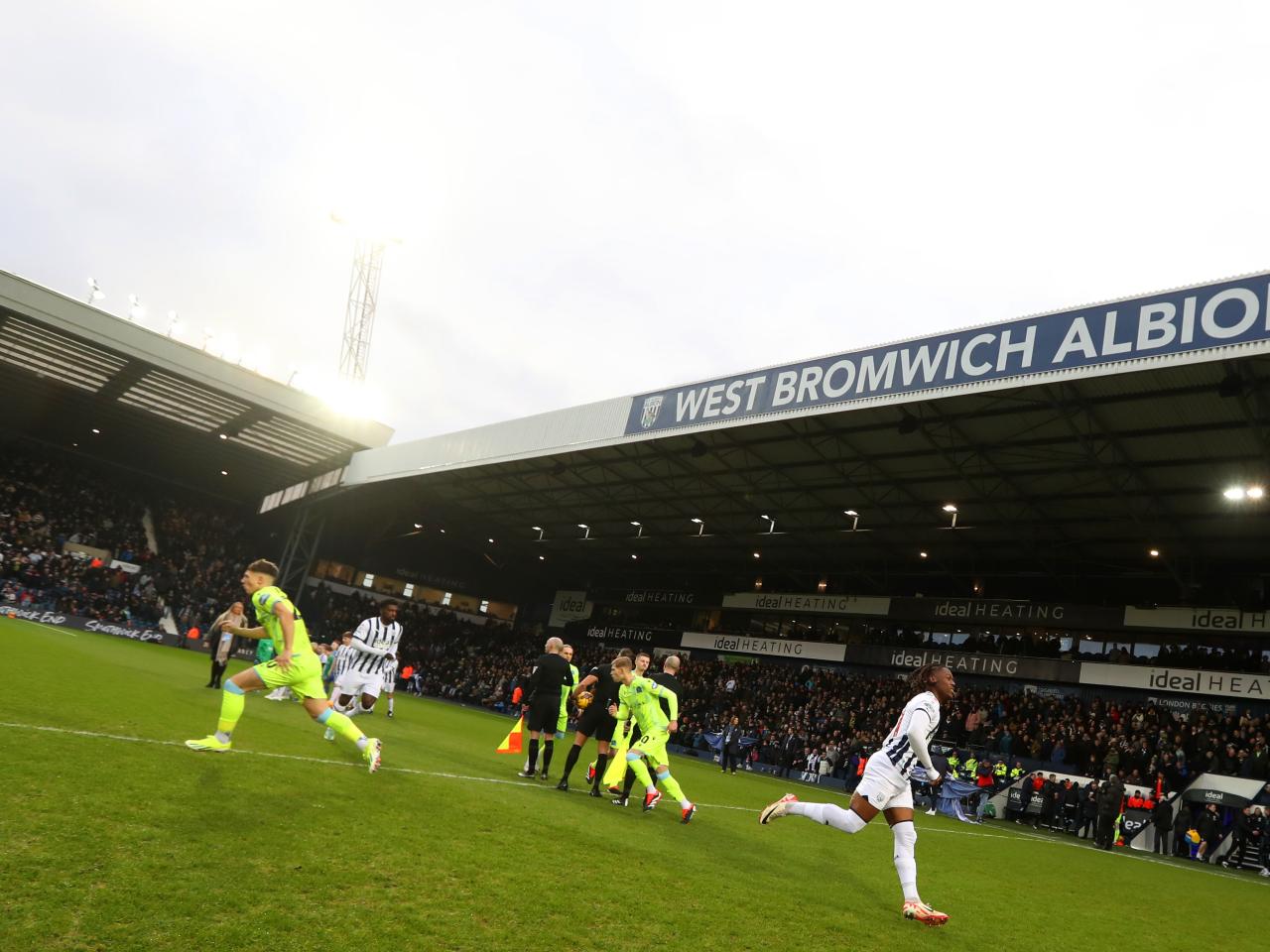 Albion players and Blackburn players break away from the line up before kick-off at The Hawthorns