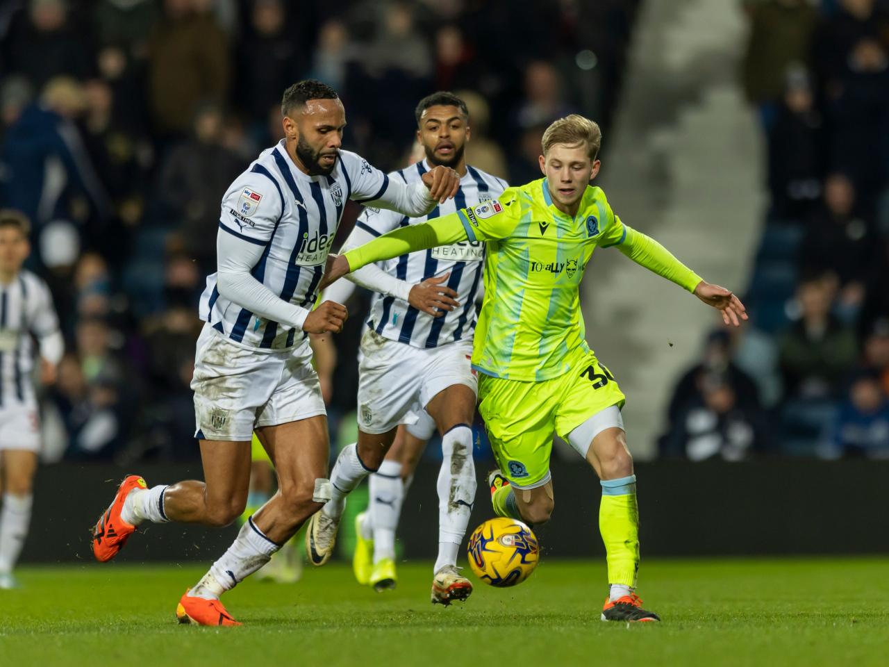 Kyle Bartley fights for the ball against a Blackburn player