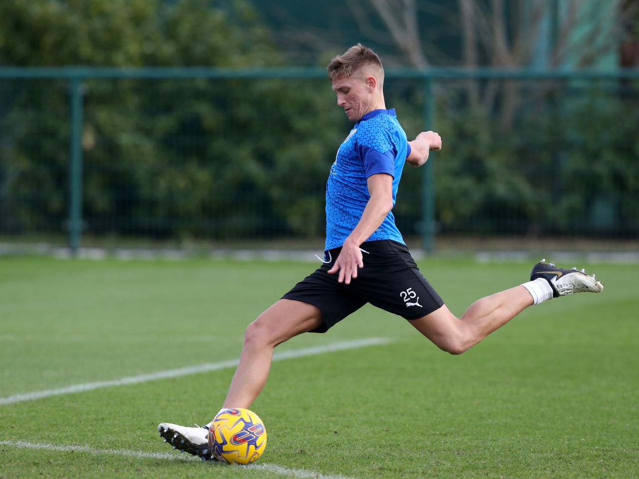 Callum Marshall striking a ball during a training session