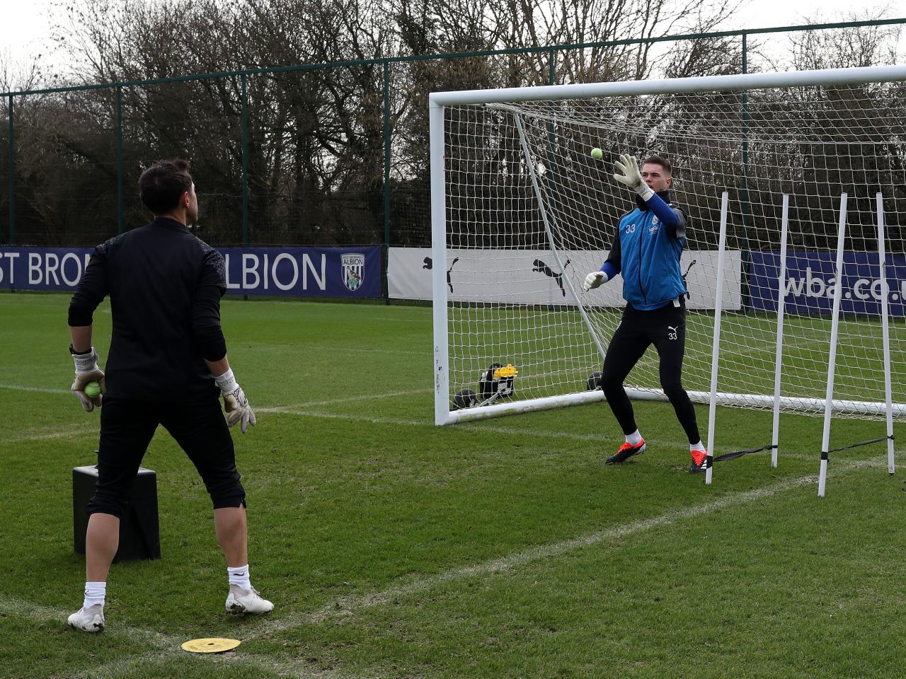 Josh Griffiths working with a tennis ball and goalkeeping coach Marcos Abad