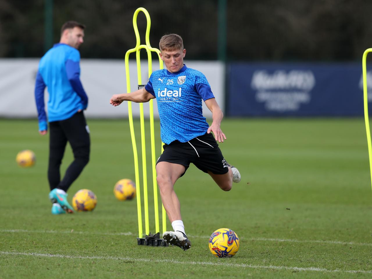 Callum Marshall striking a ball during a training session
