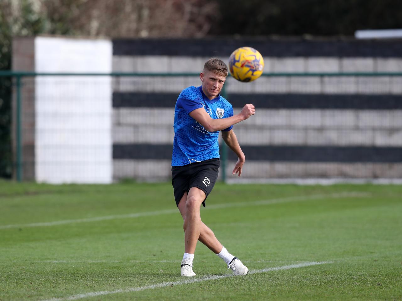 Callum Marshall striking a ball during a training session