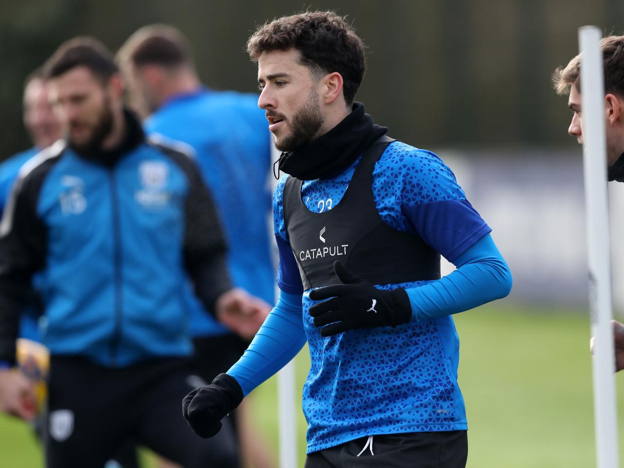 Mikey Johnston warming up ahead of a training session