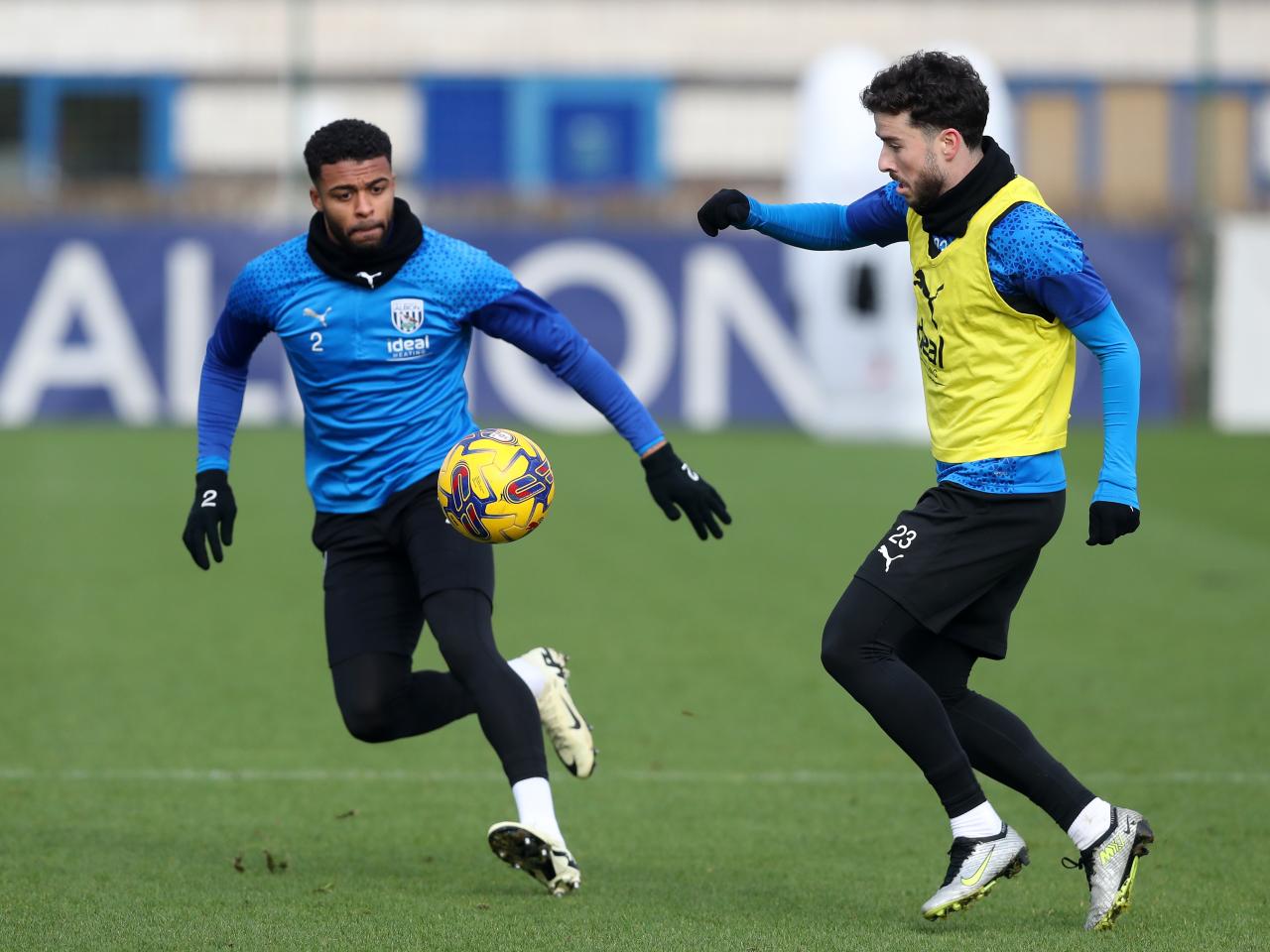 Mikey Johnston and Darnell Furlong chase the ball in training 
