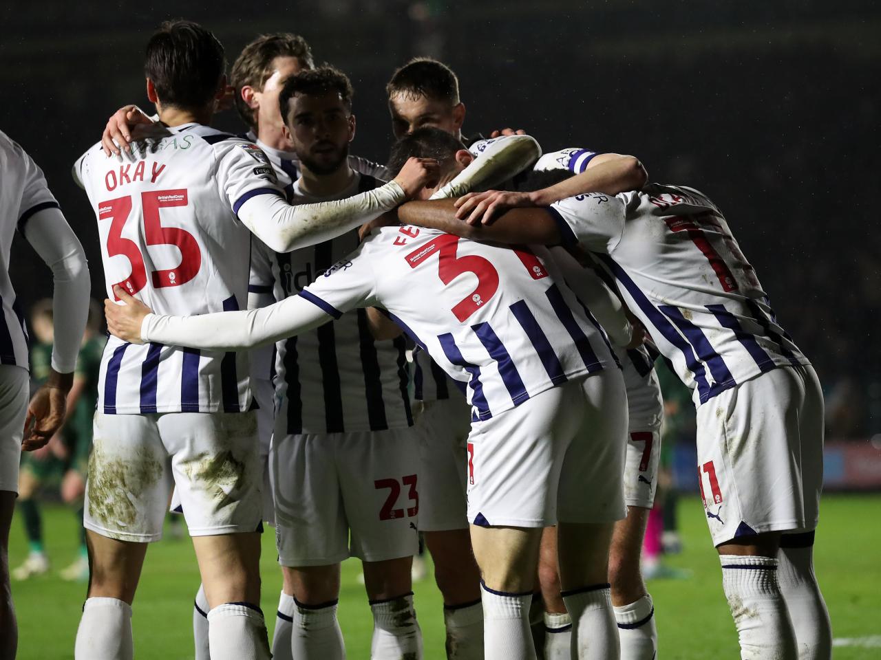 Tom Fellows celebrates scoring against Plymouth with several team-mates