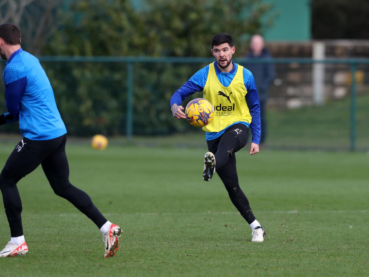 Alex Mowatt passing the ball during training