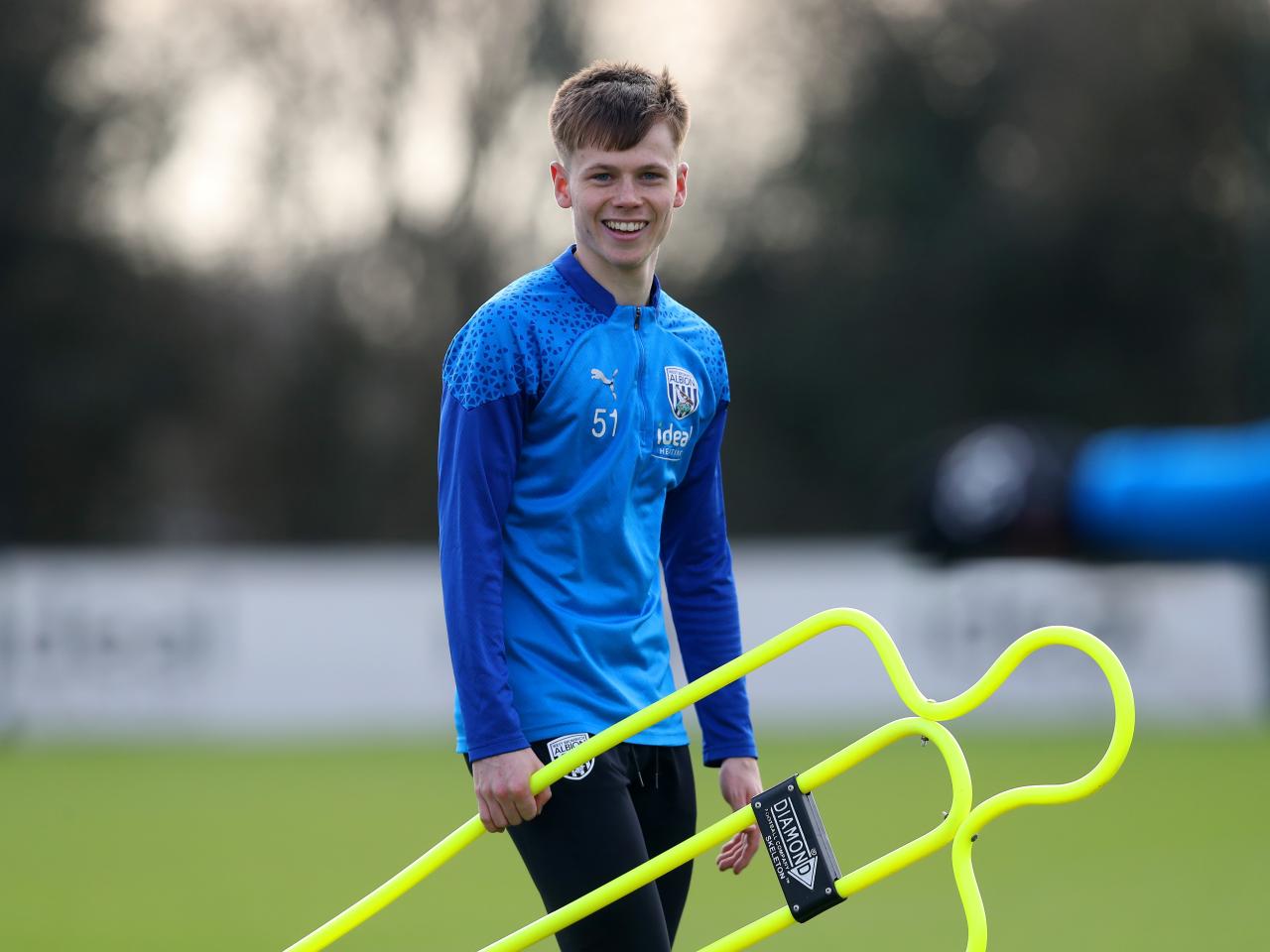 Fenton Heard holding a mannequin during a training session