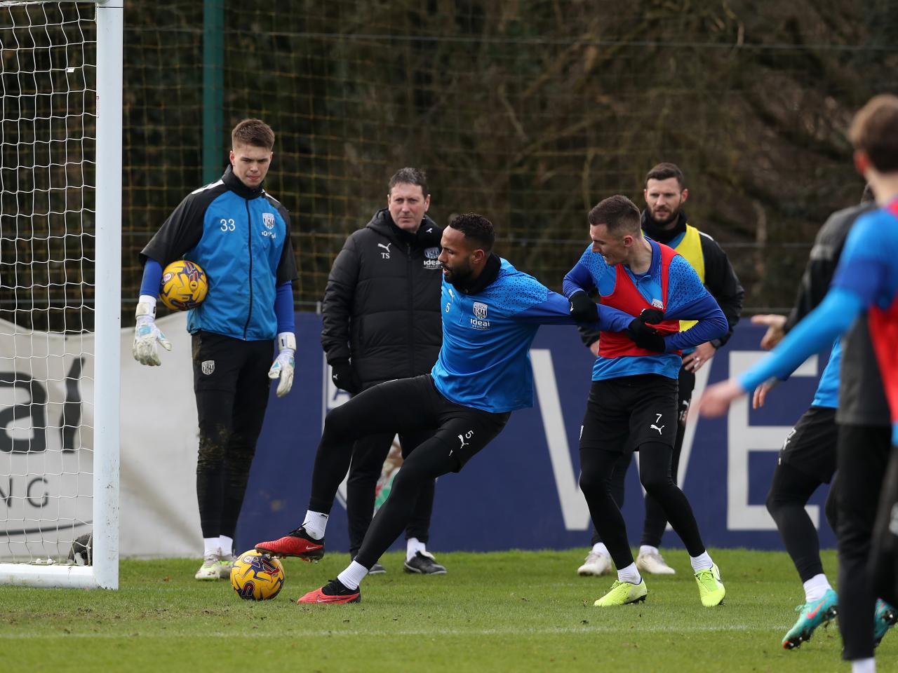 Kyle Bartley on the ball, holding off Jed Wallace during a training session