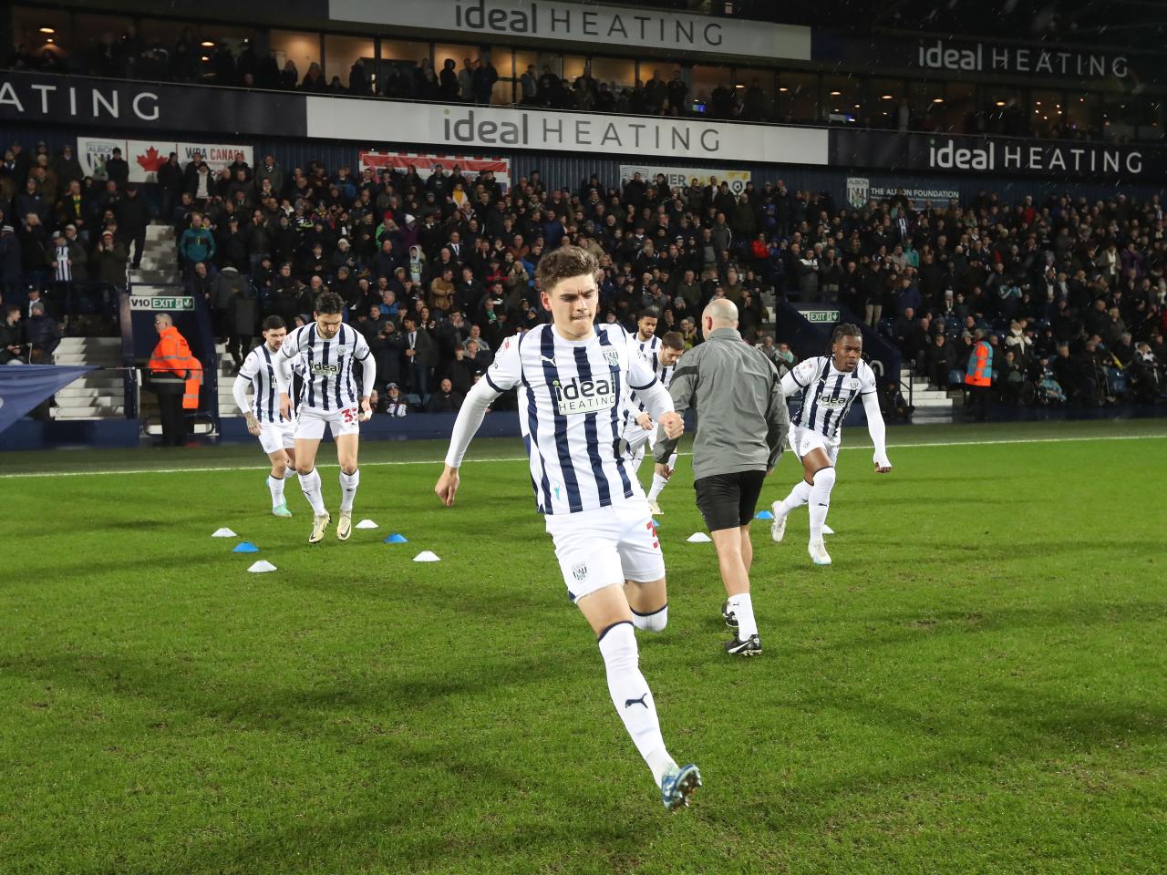 Tom Fellows warming up on the pitch moments before kick-off