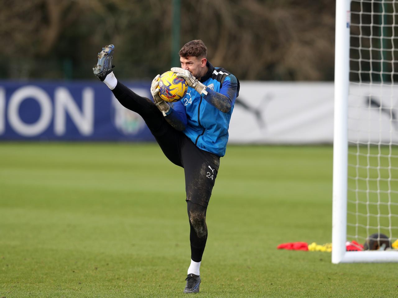 Alex Palmer in training with one of his legs up in the air