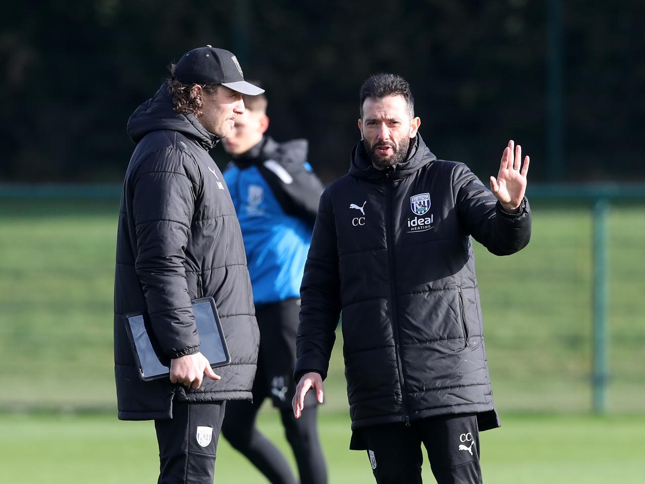 Carlos Corberán talking to coach Michael Hefele during a training session