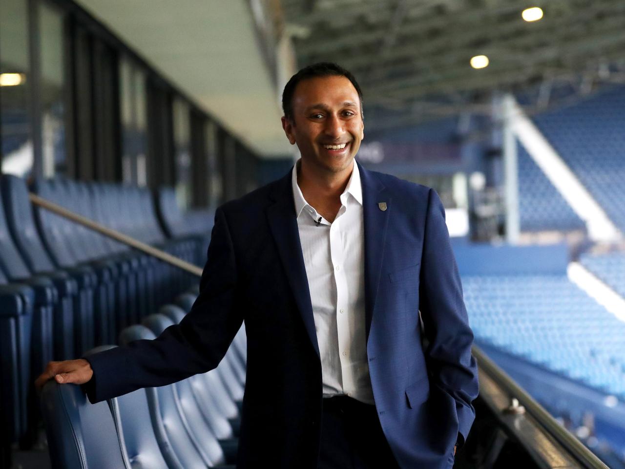 Shilen Patel stood on the balcony in the West Stand at The Hawthorns smiling at the camera