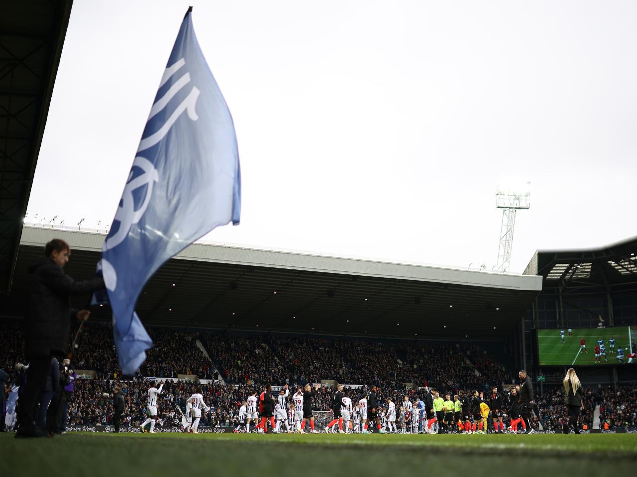 A general view of both teams coming out onto the pitch before kick-off