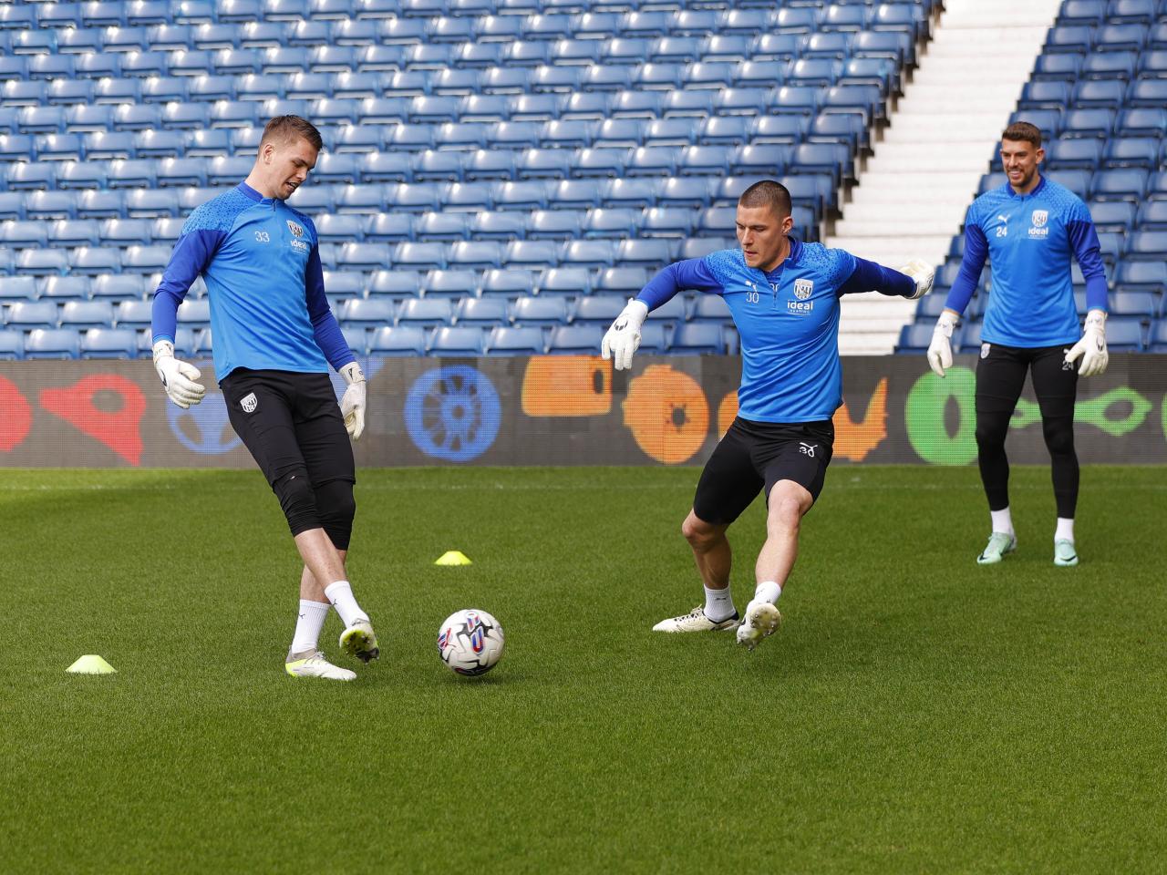Albion goalkeepers playing a passing game on the pitch at The Hawthorns during a training session