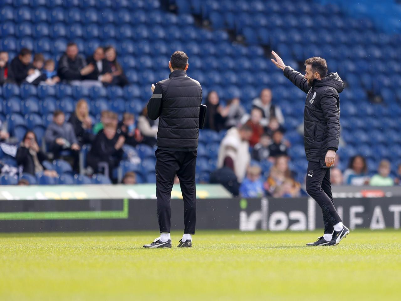 Carlos Corberán waving to supporters during a training session at The Hawthorns