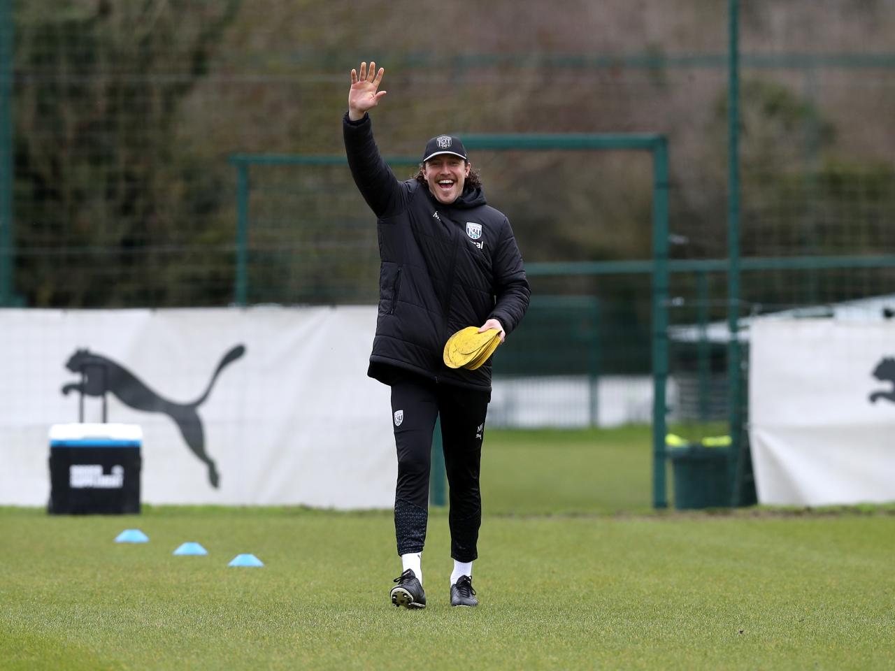 Michael Hefele waving at the camera while out on the training pitch