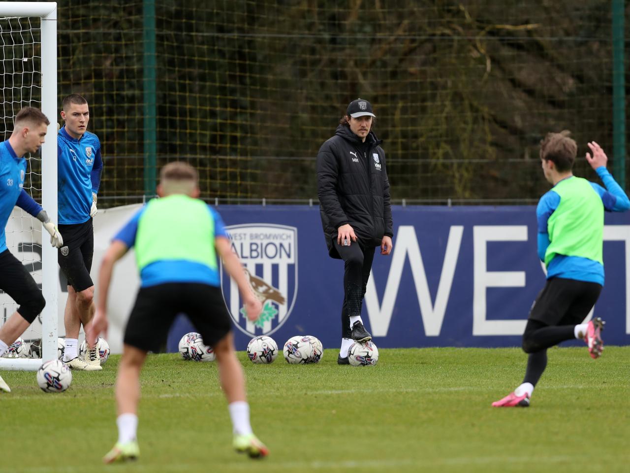Michael Hefele watching over a training session with several players involved in the drill