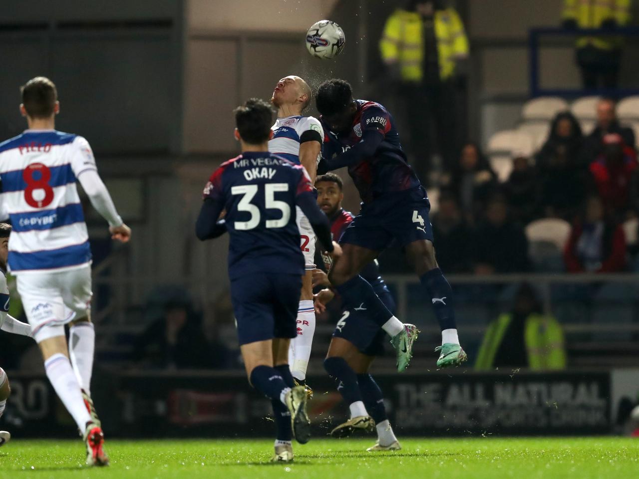 Cedric Kipre jumps to try and win a head against a QPR player 