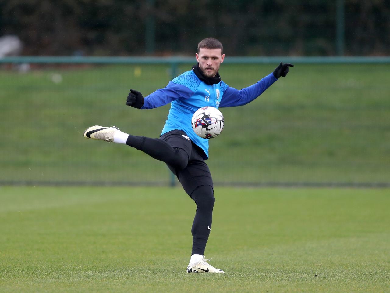 John Swift kicks the ball with his right foot in training 