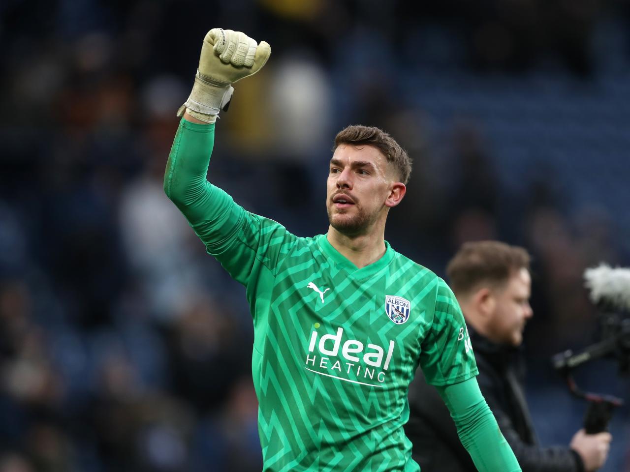 Alex Palmer with his fist raised after the full-time whistle against Bristol City