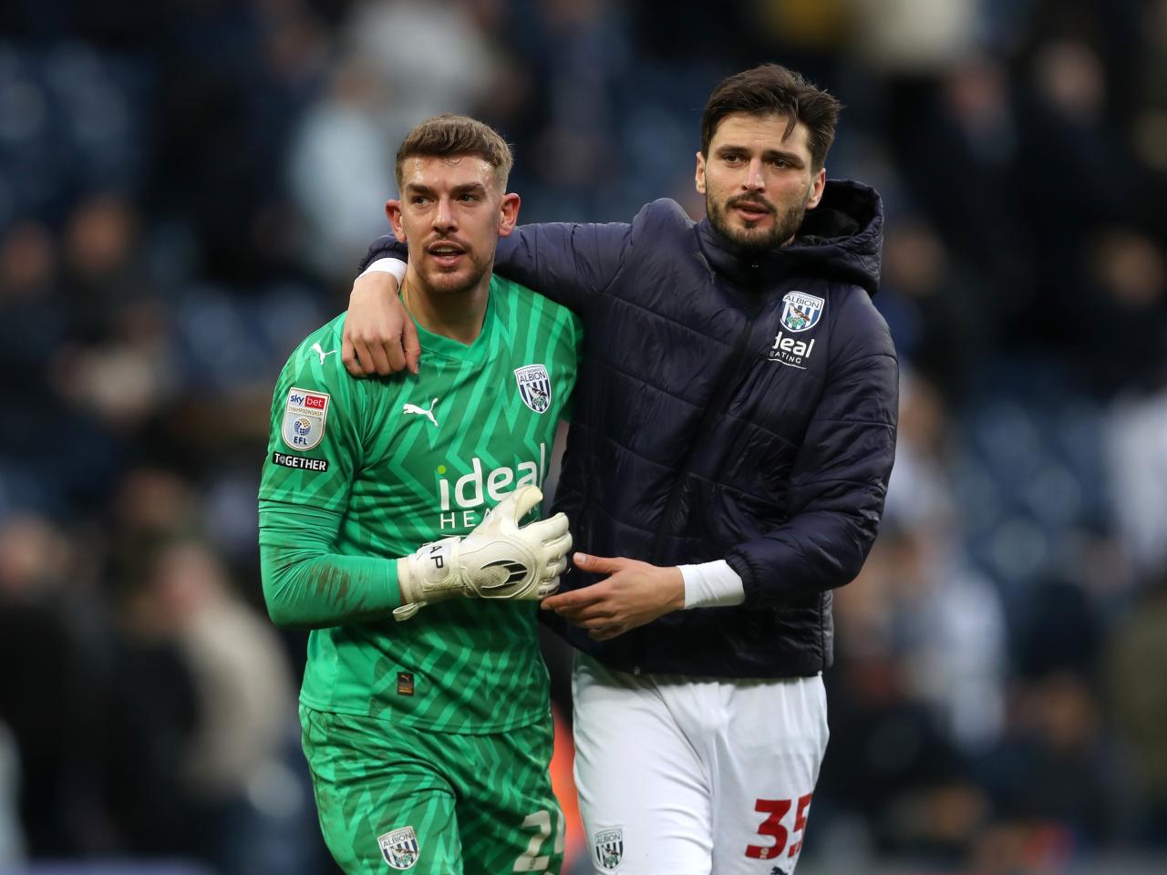 Alex Palmer and Okay Yokuslu embrace after beating Bristol City