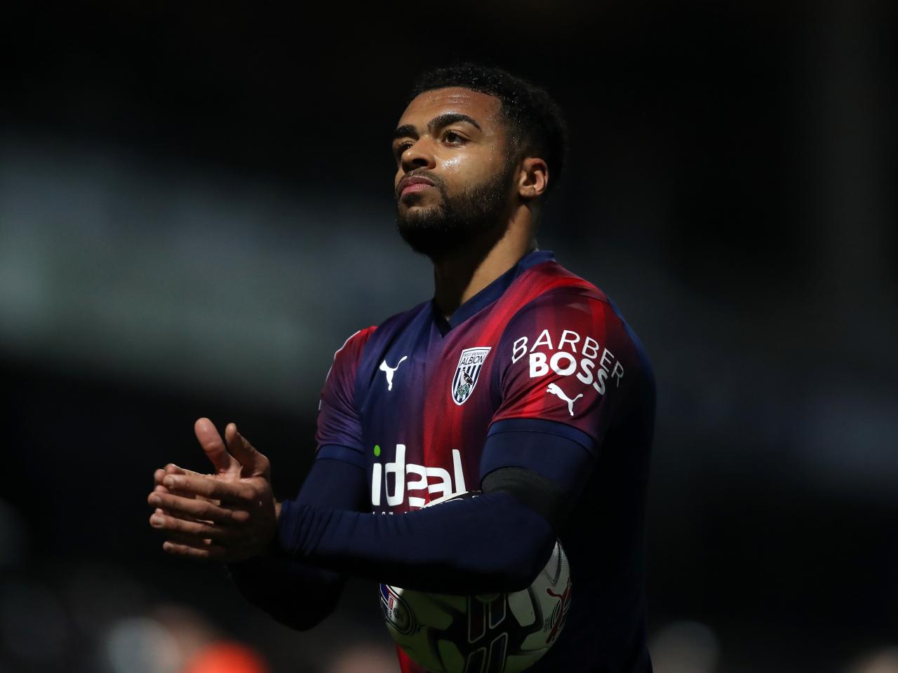 Darnell Furlong applauds Albion fans after the full-time whistle at QPR 