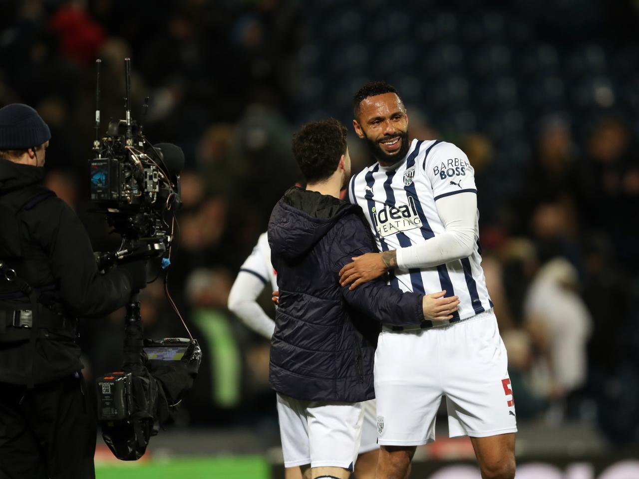 Mikey Johnston and Kyle Bartley embrace after beating Coventry 