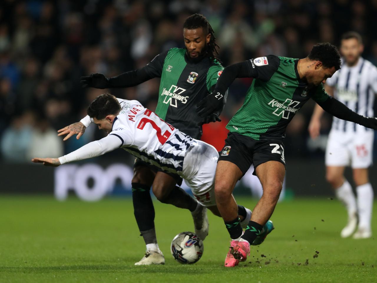 Alex Mowatt is fouled by two Coventry players 