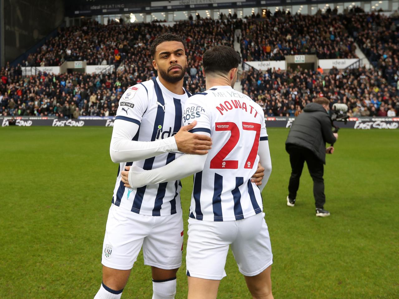 Alex Mowatt and Darnell Furlong embrace on the pitch before the game against Bristol City