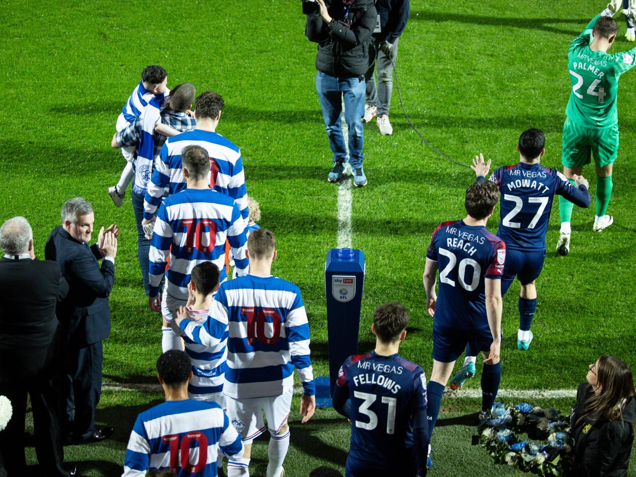 QPR and Albion players walk out on to the pitch before the game at Loftus Road
