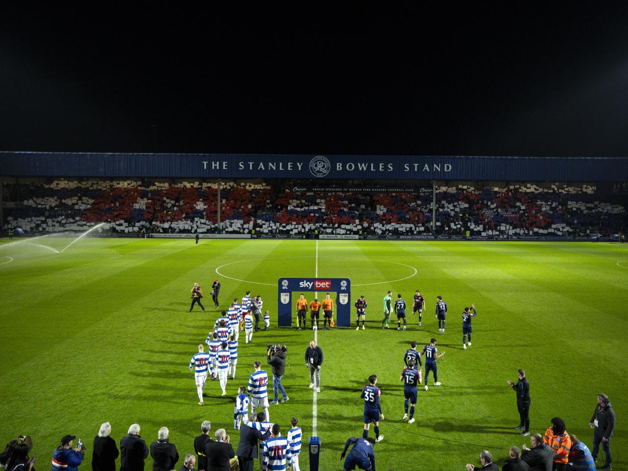 QPR and Albion players walk out on to the pitch before the game at Loftus Road