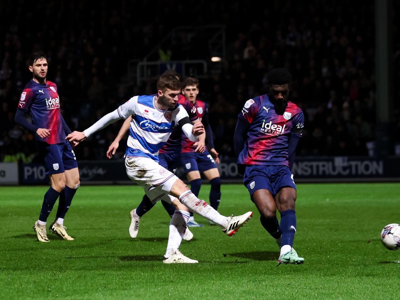 Cedric Kipre attempting to block a QPR player's shot 