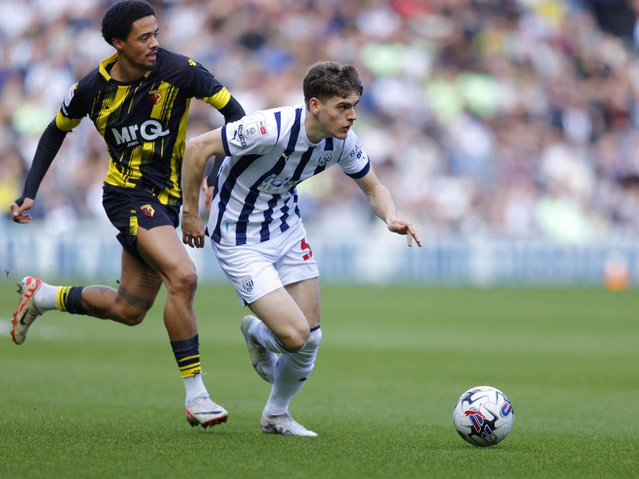 Tom Fellows running with the ball against Watford 