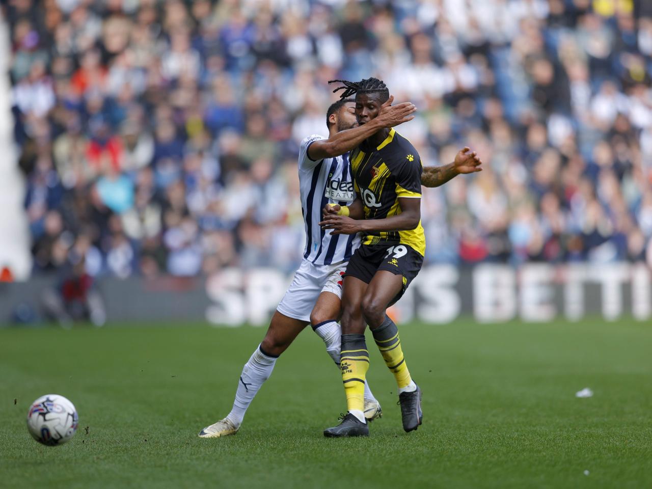 Darnell Furlong collides with a Watford player