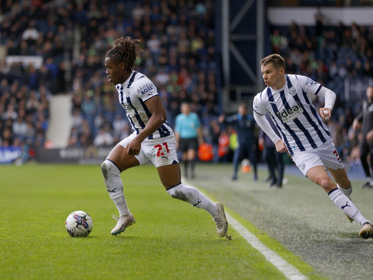 Brandon Thomas-Asante running with the ball against Watford with Conor Townsend behind him