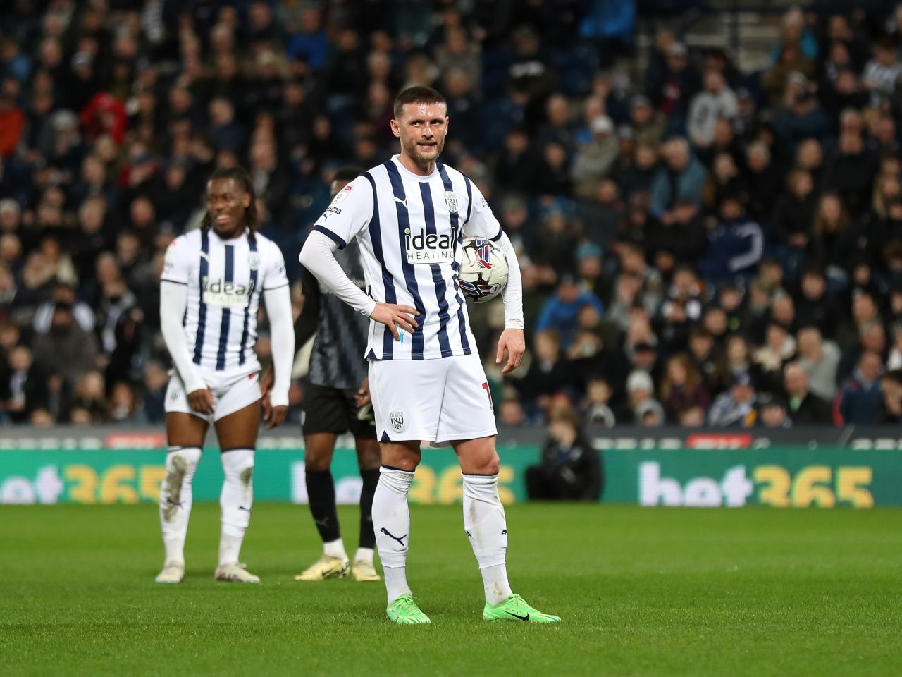 John Swift holding the ball preparing to take a penalty against Rotherham United at The Hawthorns