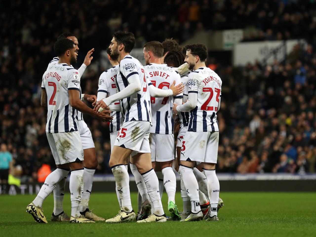 John Swift celebrates scoring against Rotherham United with several team-mates 