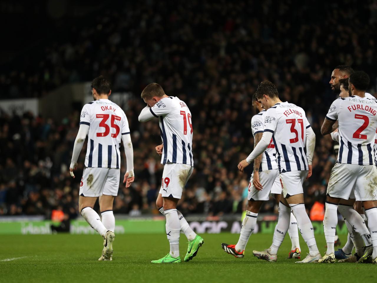 John Swift celebrates scoring against Rotherham United with several team-mates 