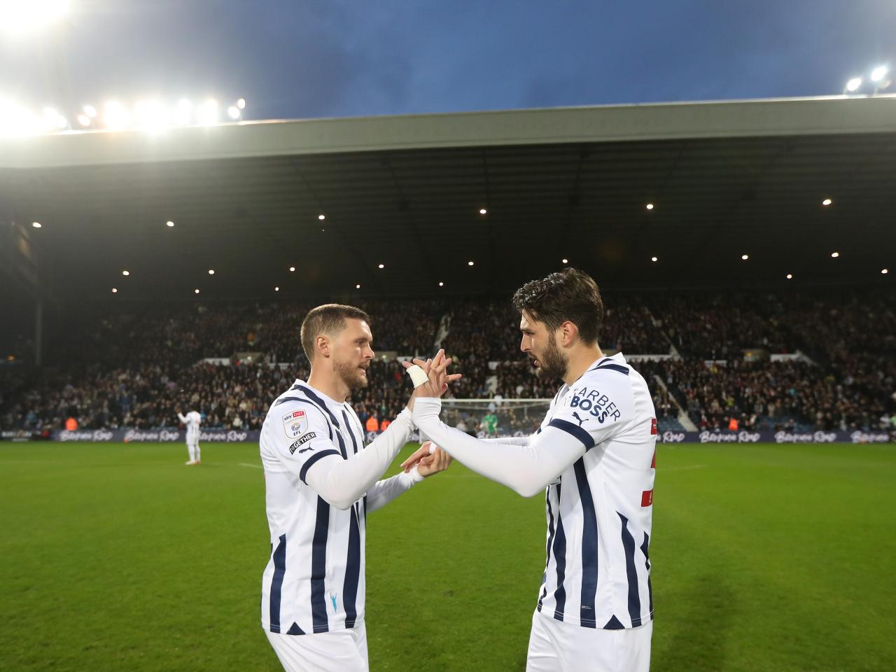 John Swift and Okay Yokulsu high five on the pitch before the Rotherham game