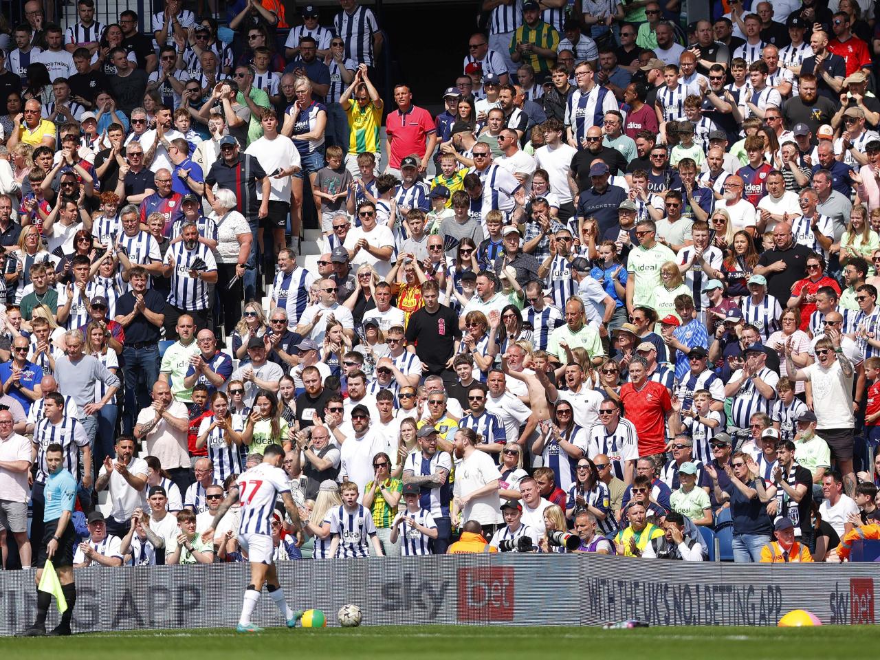 Alex Mowatt prepares to take a corner against Southampton at The Hawthorns with several Albion fans behind him